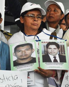 Members of the Movimiento Migrante Mesoamericano (caravan of mothers) hold up pictures of their missing loved ones